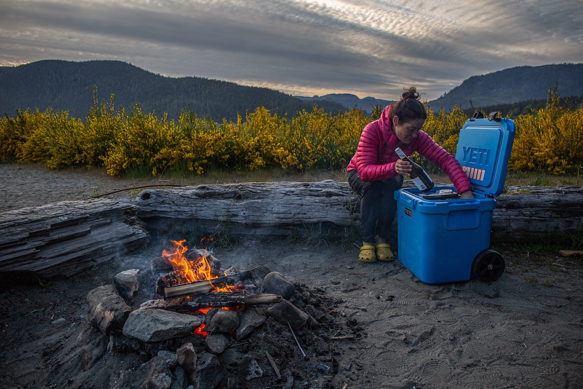 Pulling a bottle of wine out of the Yeti Roadie 48 wheeled cooler
